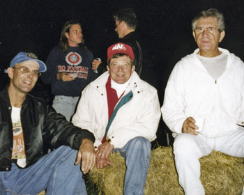 3 men sitting on hay bales